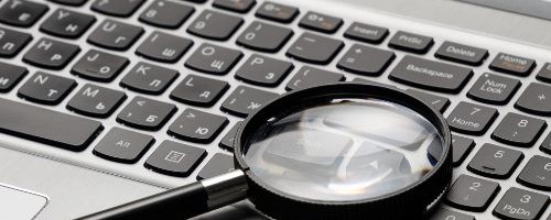 Magnifying glass on a computer keyboard